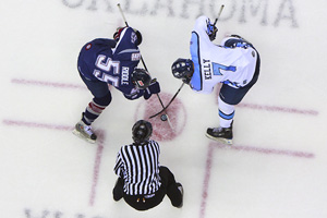Tulsa Oilers forward Troy Riddle and Wichita Thunder forward Paul Kelly face off at the BOK center Tuesday night.