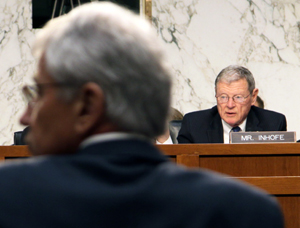 Sen. Jim Inhofe, ranking member of Senate Armed Services Committee, and Secretary of Defense Chuck Hagel look at a chart Inhofe reference during Wednesday’s committee hearing. The chart shows President Obama's plans to fund defense spending at 16 percent of the federal budget compared to President Reagan's federal budget in 1989 that funded defense at 28 percent. 