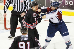 Oilers Eric Tallent (White jersey), dukes it out with J.P. Chabot. Photo by Kevin Pyle