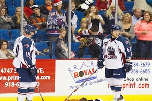 "Luke Judson (left) and T.J. Caig watch the tossing of teddy bears after Tulsa's first goal Friday night" - Photo by Kevin Pyle