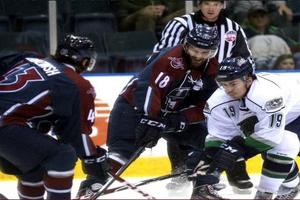 Adam Pleskach (18) and Ricards Birzinsh (43) battle the Everblades Alex Lavoie (19)