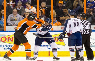 Eric Tallent and Ryley Gratham duke it out in front of Tommy Mele and a linesman early in Friday's contest.