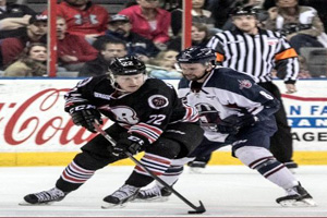 Scott Macauley (8) battles the Rush's Kale Kerbashian (22) on Friday night.