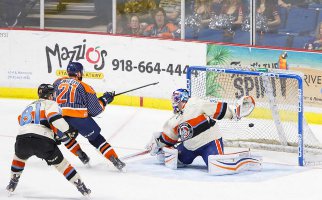 Ben Walker (21) backhands puck past Mavericks Goalie Parker Milner.