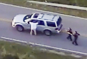 Crutcher and police (Photo frame capture from helicopter video)